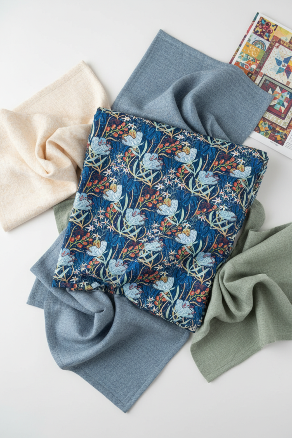 Whimsy Anemones and Berry Pods Blue quilting cotton styled with coordinating fabrics for quilt color planning and floral project inspiration