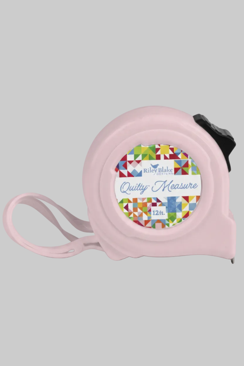 Riley Blake Quilty 12 ft retractable pink tape measure on a light gray background for quilting and sewing projects.