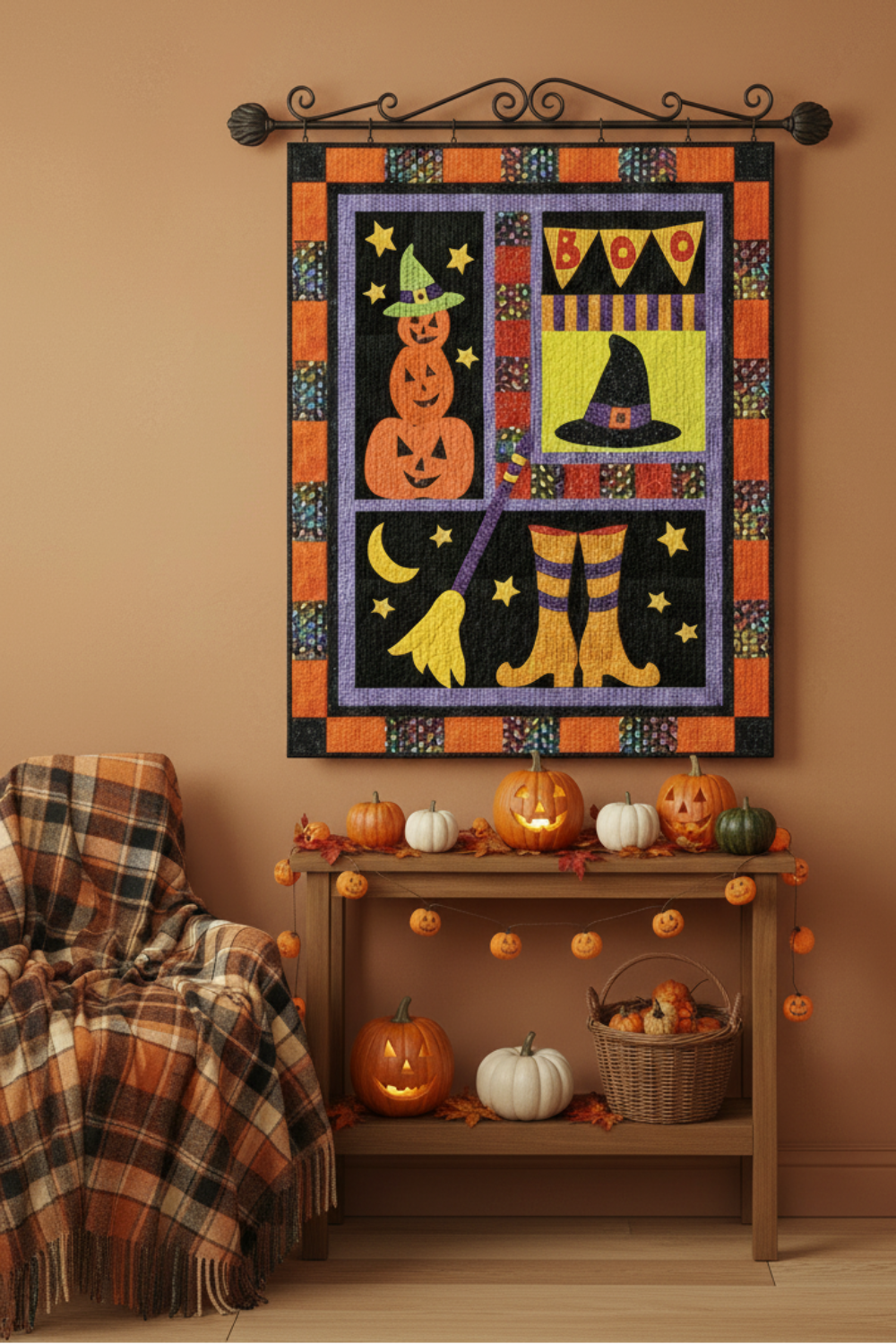 Halloween-themed wall art with pumpkins, witch boots, and a 'BOO' sign on a brown wall.