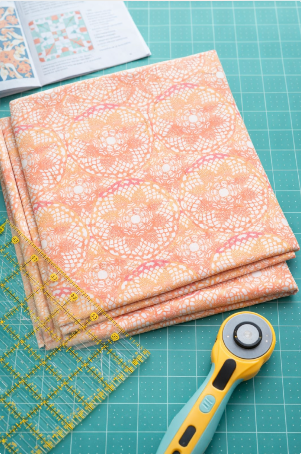 Patricia Coral Lace fabric swatch showing true coral color and lace scale detail