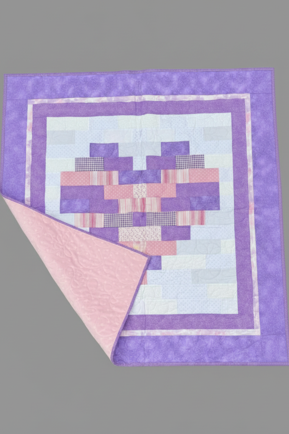 Quilt with a geometric pattern on a gray background
