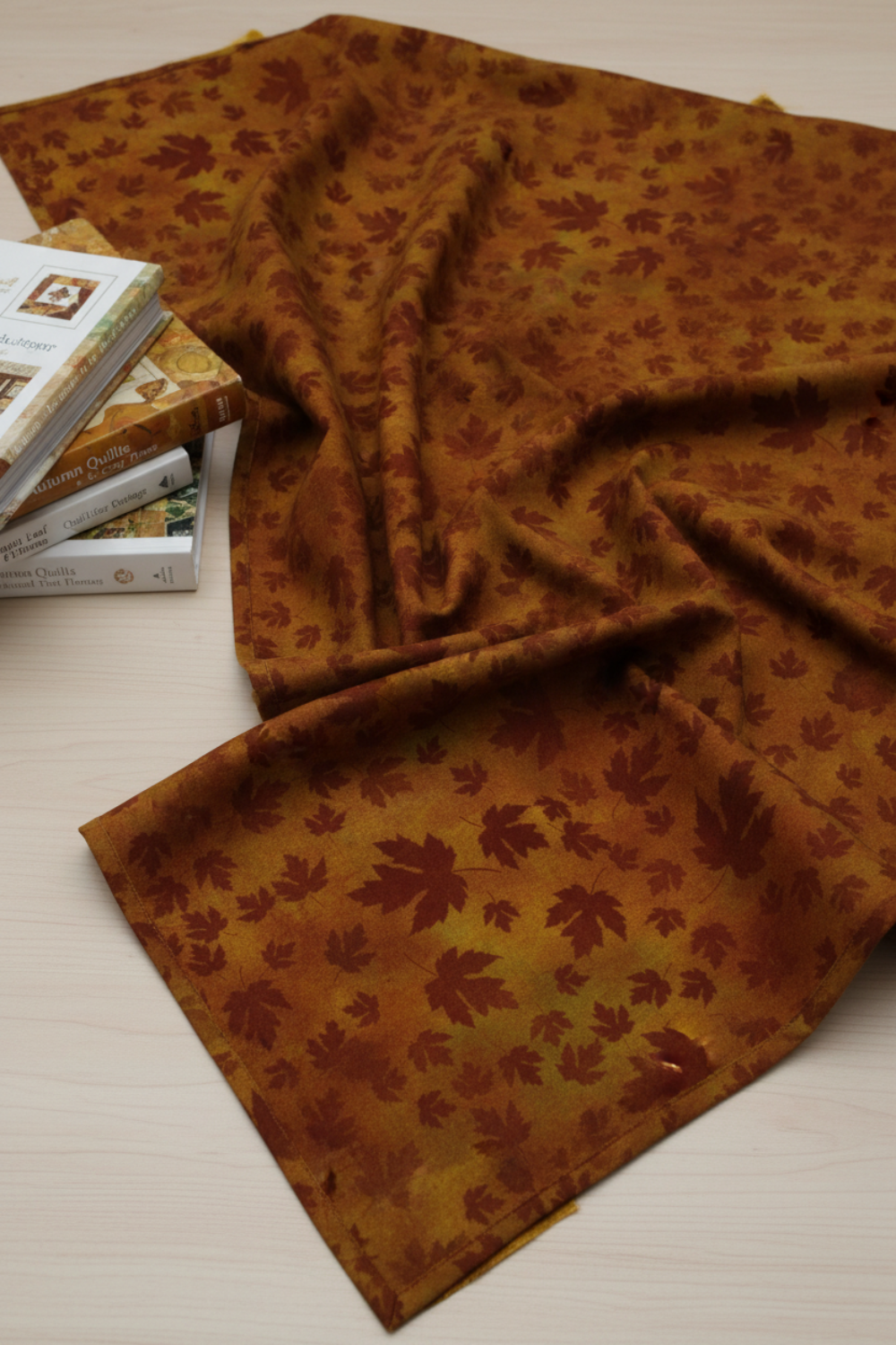 Autumn Celebration Brown Maple Leaves quilting cotton styled on cutting mat with quilting tools – lifestyle shot for quilters