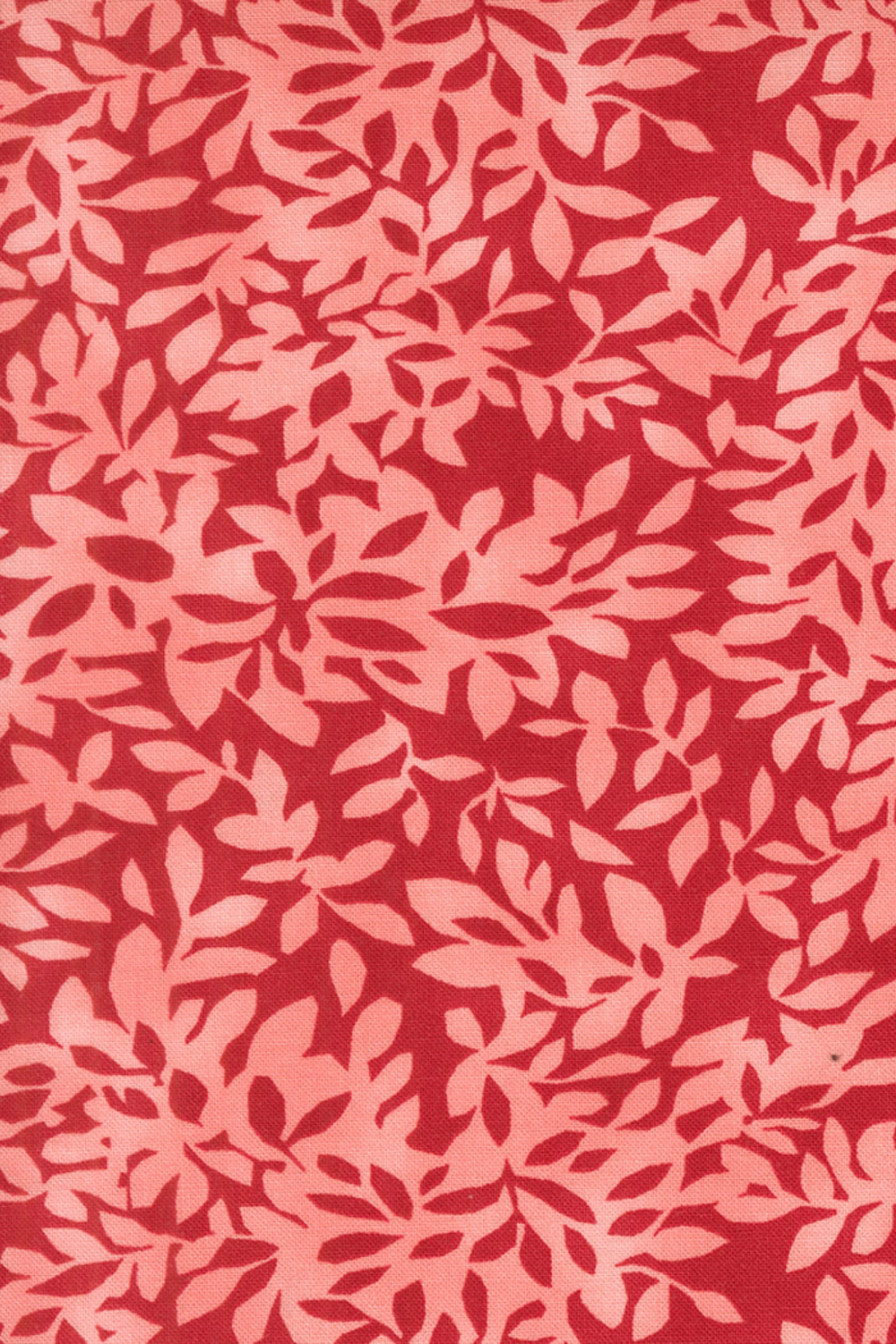 Superbloom Leafy Geranium fabric by Robin Pickens for Moda Fabrics, featuring overlapping coral-pink leafy branches on a rich red ground.