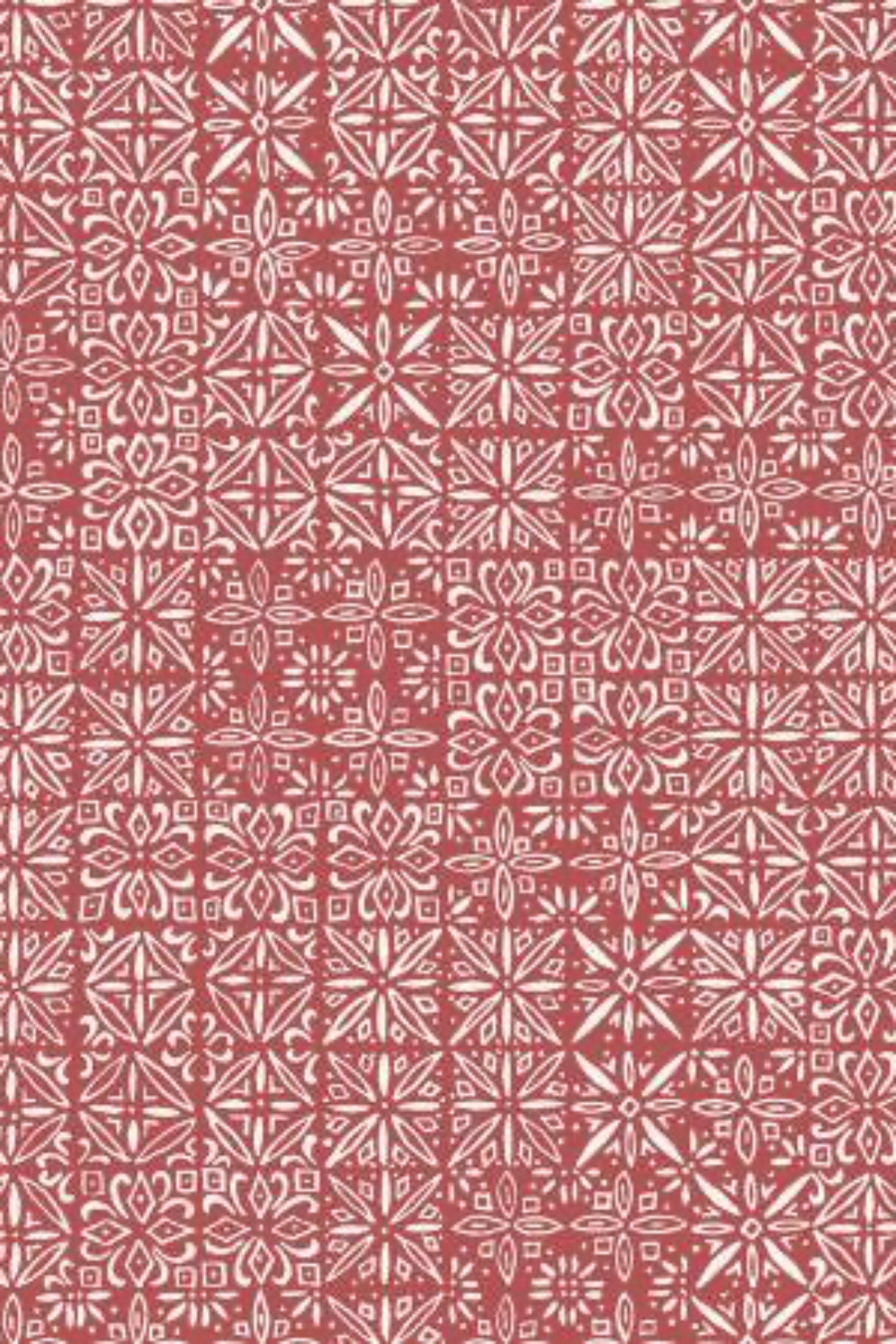 Detailed view of Breezeway Medium Red Tiles fabric by Maywood Studio, showing layered cream geometric motifs and medallion-style blocks on a warm red ground.