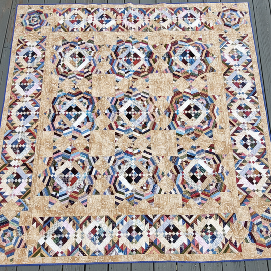 Handmade Trail Mix scrappy patchwork quilt laid flat showing colorful geometric blocks