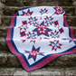 Quilt with star pattern on stone steps outdoors