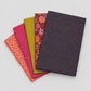 Thatched Shadow deep purple fabric by Robin Pickens for Moda Fabrics shown in a coordinating fabric fan with Thatched Fuchsia and Thatched Green Curry — all available at IraRobi Quilts.