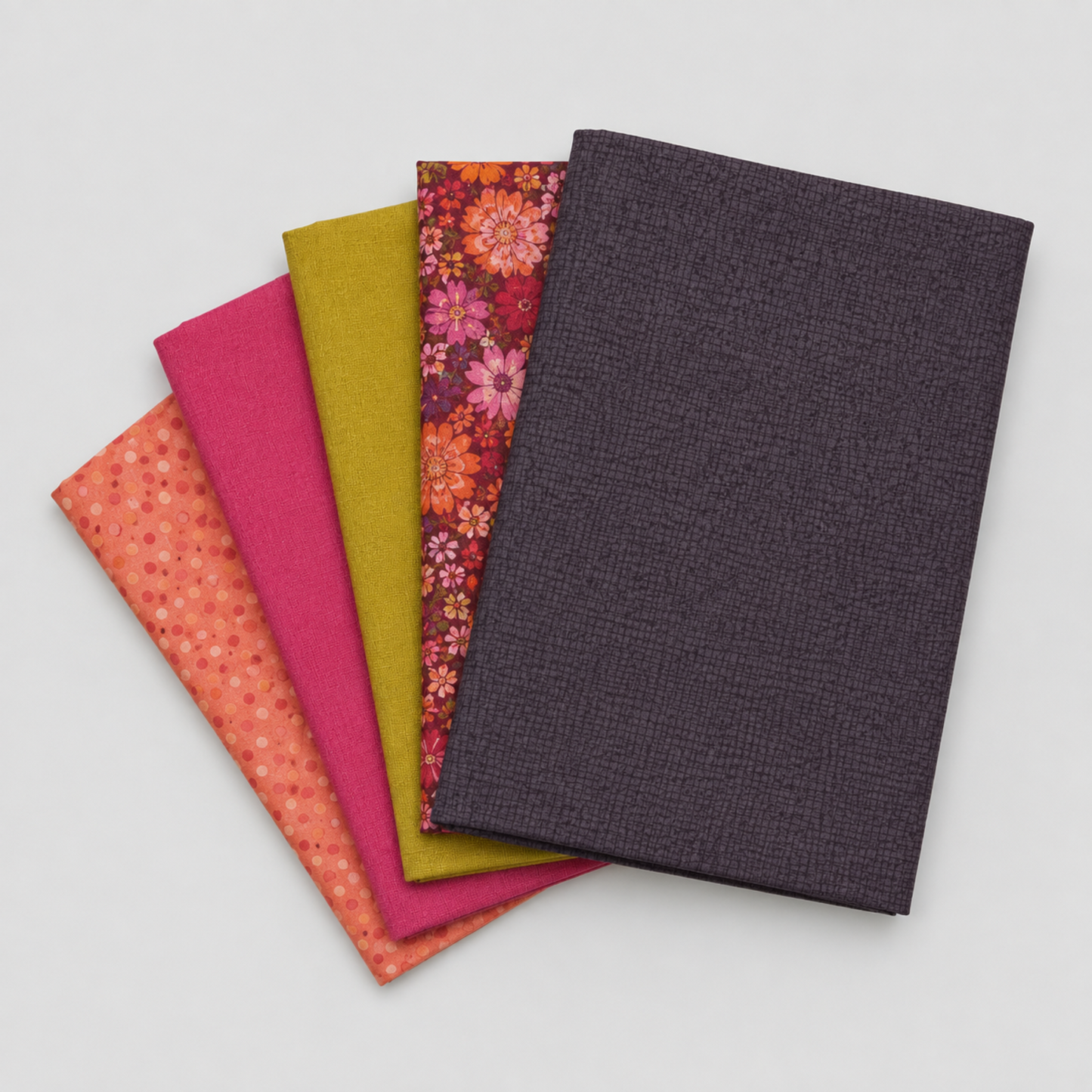 Thatched Shadow deep purple fabric by Robin Pickens for Moda Fabrics shown in a coordinating fabric fan with Thatched Fuchsia and Thatched Green Curry — all available at IraRobi Quilts.