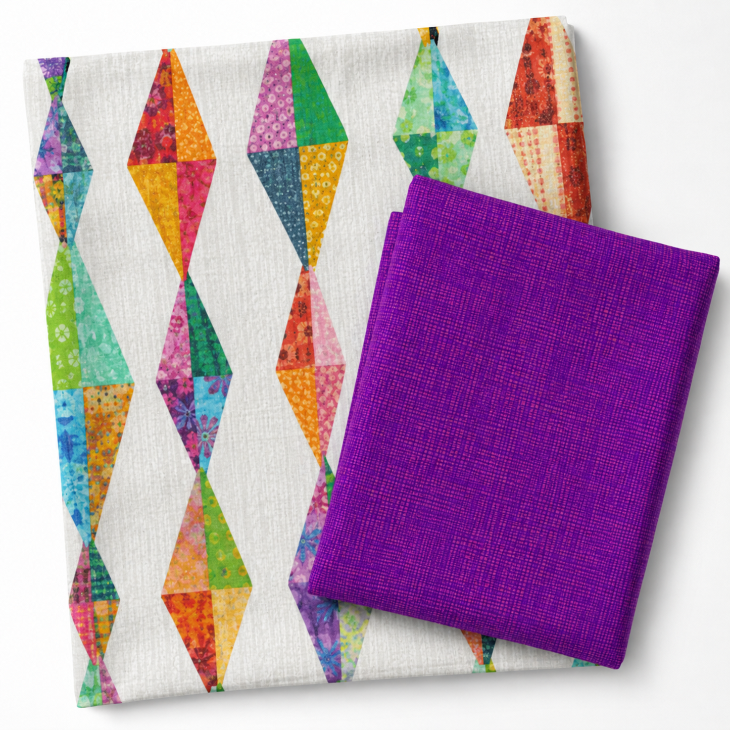 Interwoven Plum quilting fabric by Jason Yenter paired with a Diamond Daze quilt by Sew Kind of Wonderful — vivid purple-violet Interwoven geometric crosshatch fabric folded alongside the finished quilt showing elongated diamond blocks in coordinating jewel-tone fabrics