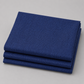 Thatched Navy quilting cotton fabric by Robin Pickens for Moda Fabrics neatly folded in a stack on a light grey surface showing the rich deep navy blue tonal crosshatch texture and raw cut edges. 100% cotton, 43–44" wide. Available at IraRobi Quilts.
