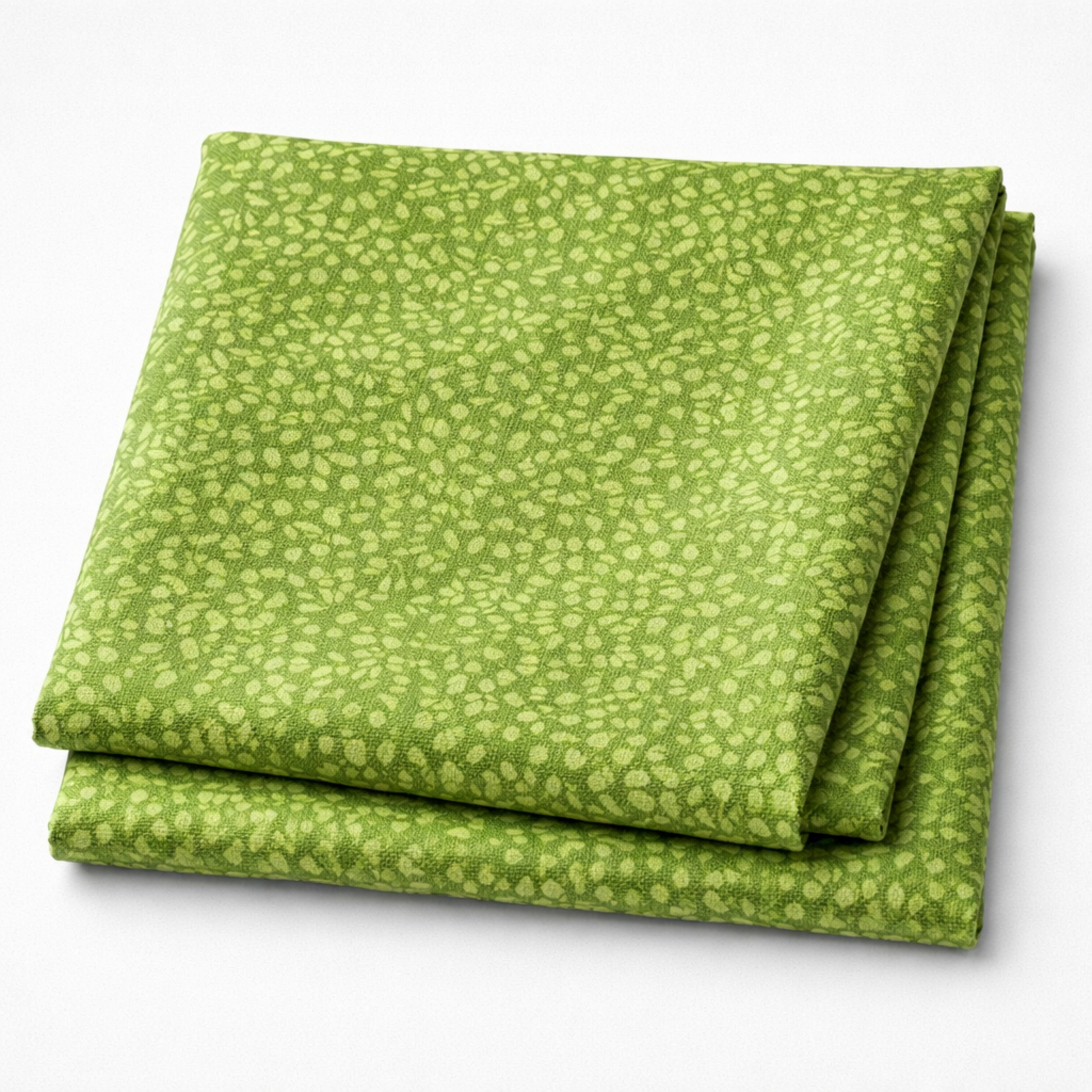 On the Go Leaves Green quilting cotton folded stack showing fabric body and natural green tones