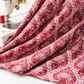 Nature's Winter Red Snowflake Ogee quilting cotton draped to show fabric softness and snowflake ogee detail