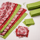 Nature's Winter Red Snowflake Ogee quilting cotton in progress with coordinating fabrics and rotary cutter – project inspiration