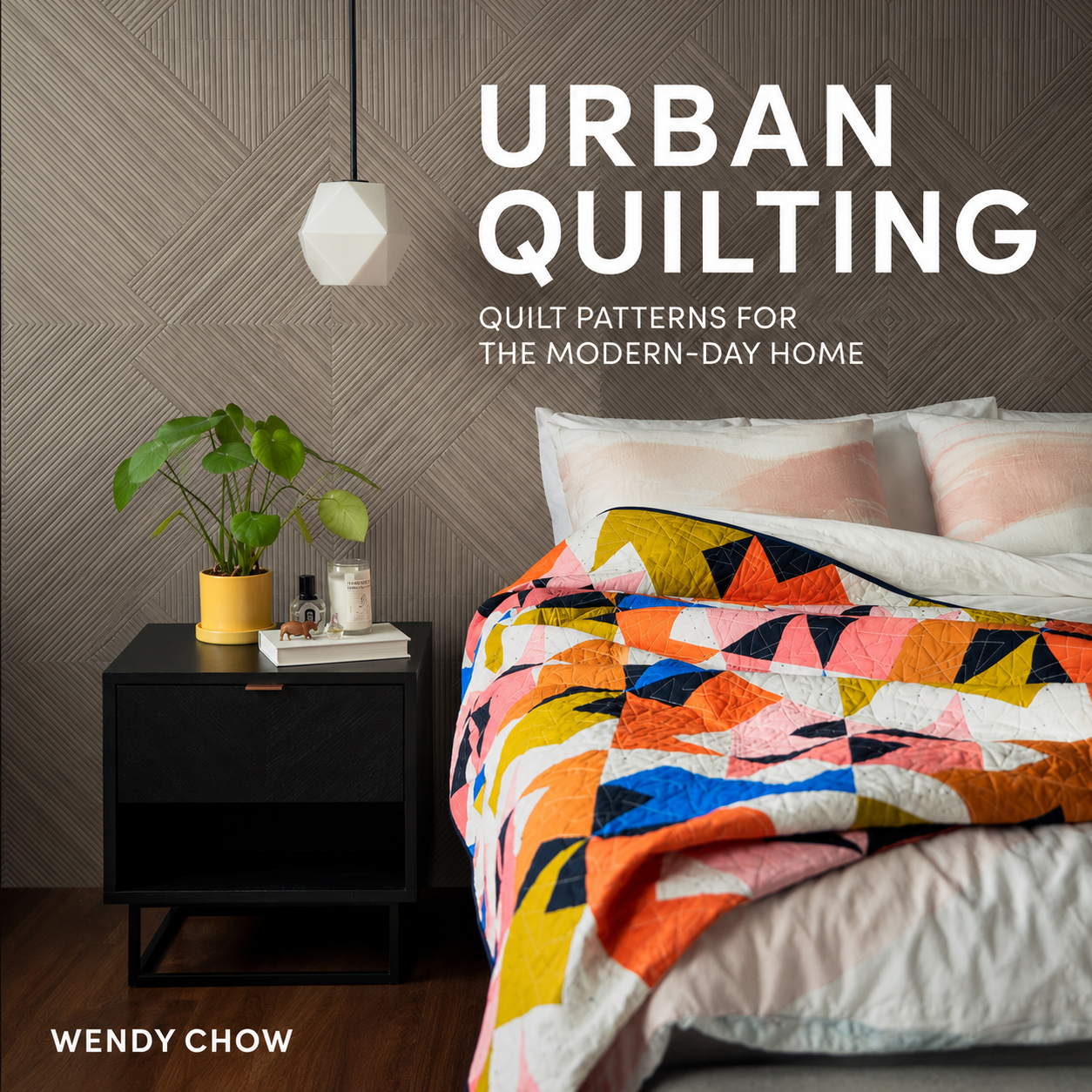 Urban Quilting book cover by Wendy Chow — bold geometric quilt draped over a bed in a modern bedroom setting
