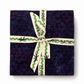 Island Batik Savannah Batiks Charm Pack – 42 precut 5" squares in deep purple and navy hand-dyed batik cotton, tied with Island Batik ribbon
