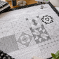 Machine Quilting Skillbuilder Panel I by Renae Allen on a sewing machine in a cozy quilting studio — black and white free-motion quilting practice panel with feathers, loops, hearts, and swirls — "Quilting is my happy place" sign, notebook with quilting practice checklist, black and white fabrics, thread, and measuring tape — available at IraRobi Quilts