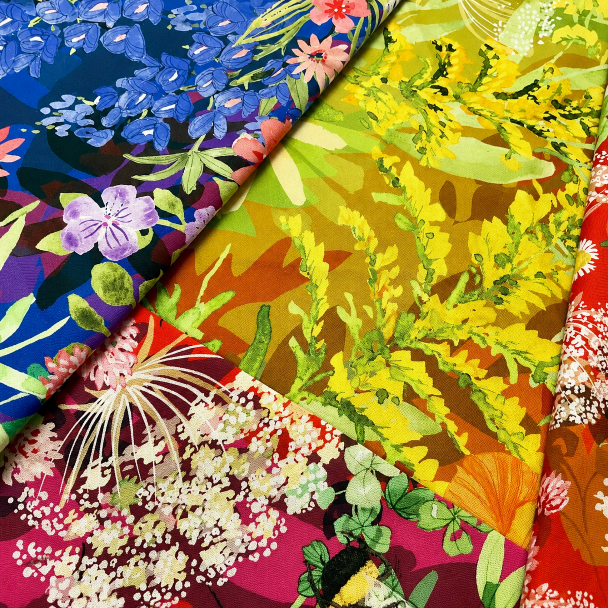 Wild Blossoms Rainbow quilting cotton by Robin Pickens for Moda Fabrics — single yard of fabric folded to show multiple colorways of the rainbow ombré print including blue bluebells, chartreuse yellow goldenrod, magenta wildflowers, and red poppies — available at IraRobi Quilts