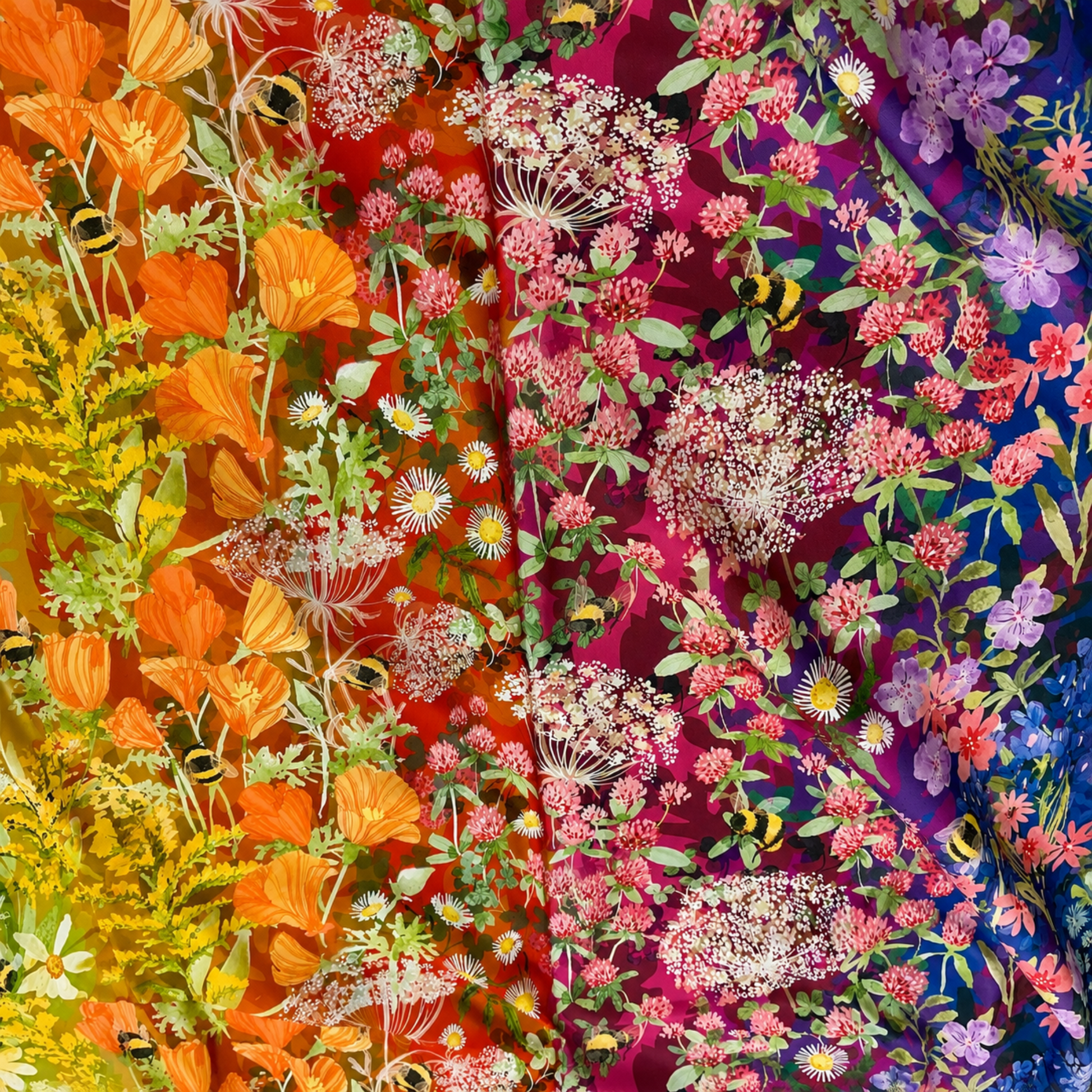 **Alt text:**

`Wild Blossoms Rainbow quilting cotton by Robin Pickens for Moda Fabrics — draped fabric showing full rainbow ombré sweep from cobalt blue with purple wildflowers and bumblebees through magenta clover and Queen Anne's lace, vivid red, orange California poppies, to golden yellow goldenrod — available at IraRobi Quilts`