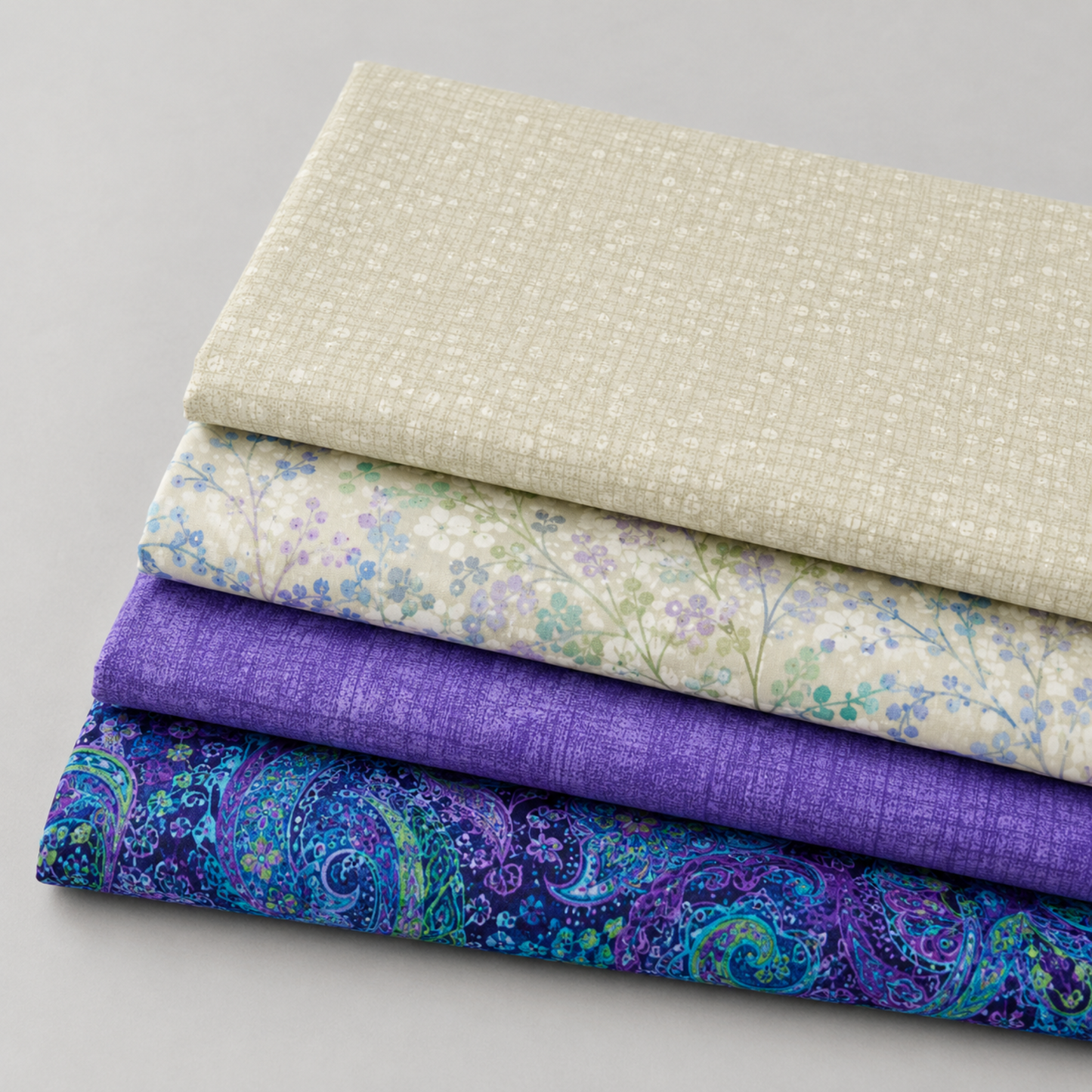Dotty Thatched Washed Linen fabric stacked with coordinating quilting cottons – cream dot texture blender by Robin Pickens for Moda Fabrics, paired with floral, purple thatched, and paisley prints