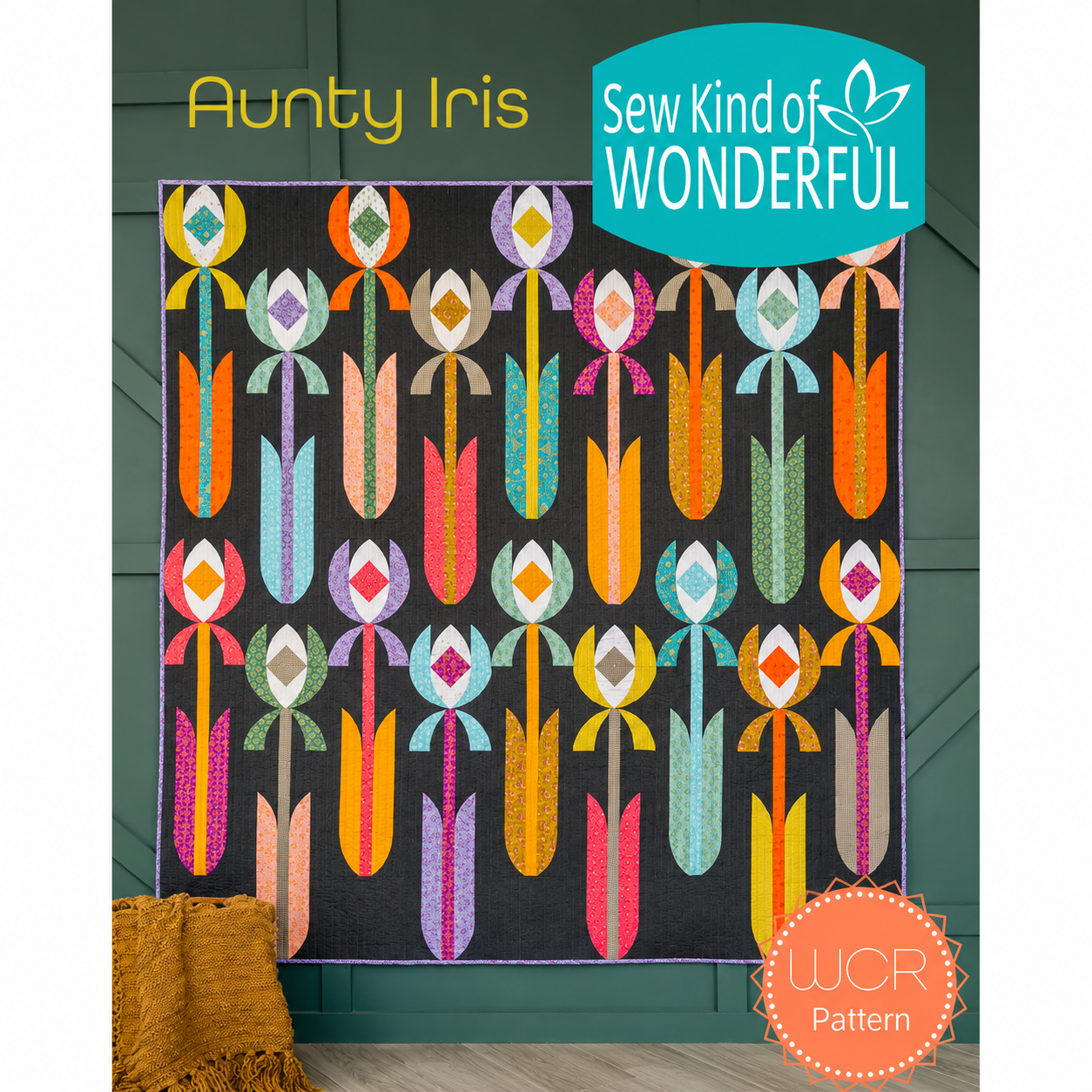 Aunty Iris quilt pattern by Sew Kind of Wonderful — modern floral WCR quilt with flowing curved iris flower blocks in bold multicolor prints on dark background, 63 x 63 inches, all skill levels
