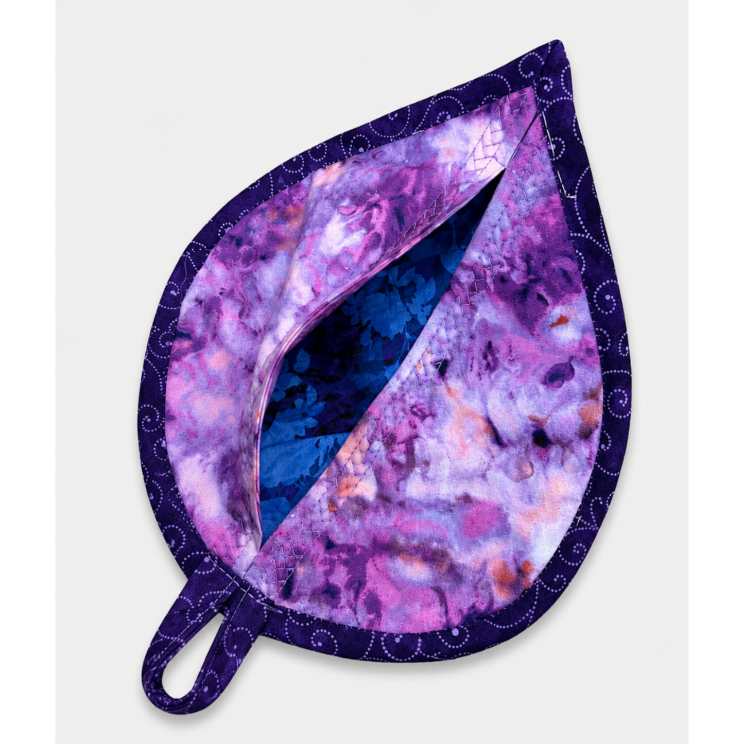 Leaf-Shaped Quilted Hot Pad – Indigo Berry, pocket open showing vivid cobalt blue floral lining inside, with purple and pink watercolor marbled back and deep navy dot-swirl border binding – handmade by IraRobi Quilt