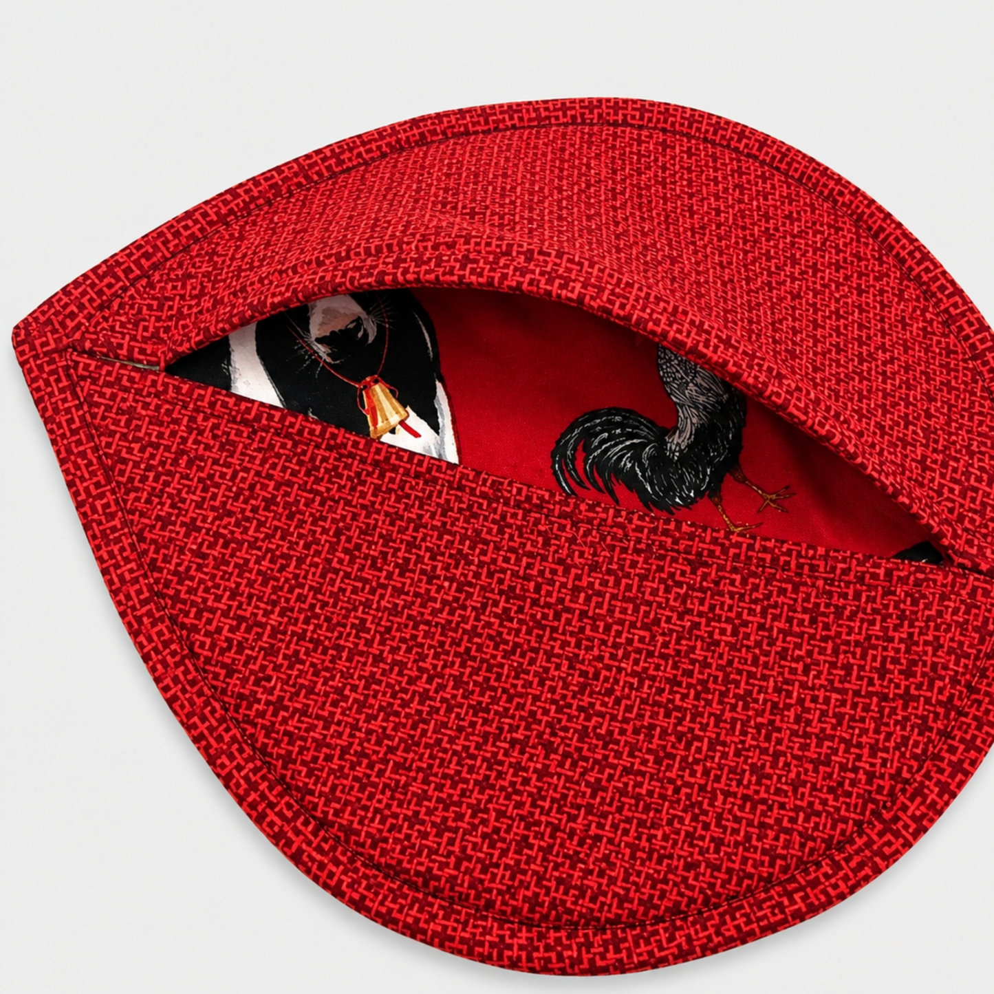 Leaf-Shaped Quilted Hot Pad – Christmas Red folded open to reveal coordinating farm animal lining fabric with cows and roosters – handmade by IraRobi Quilts