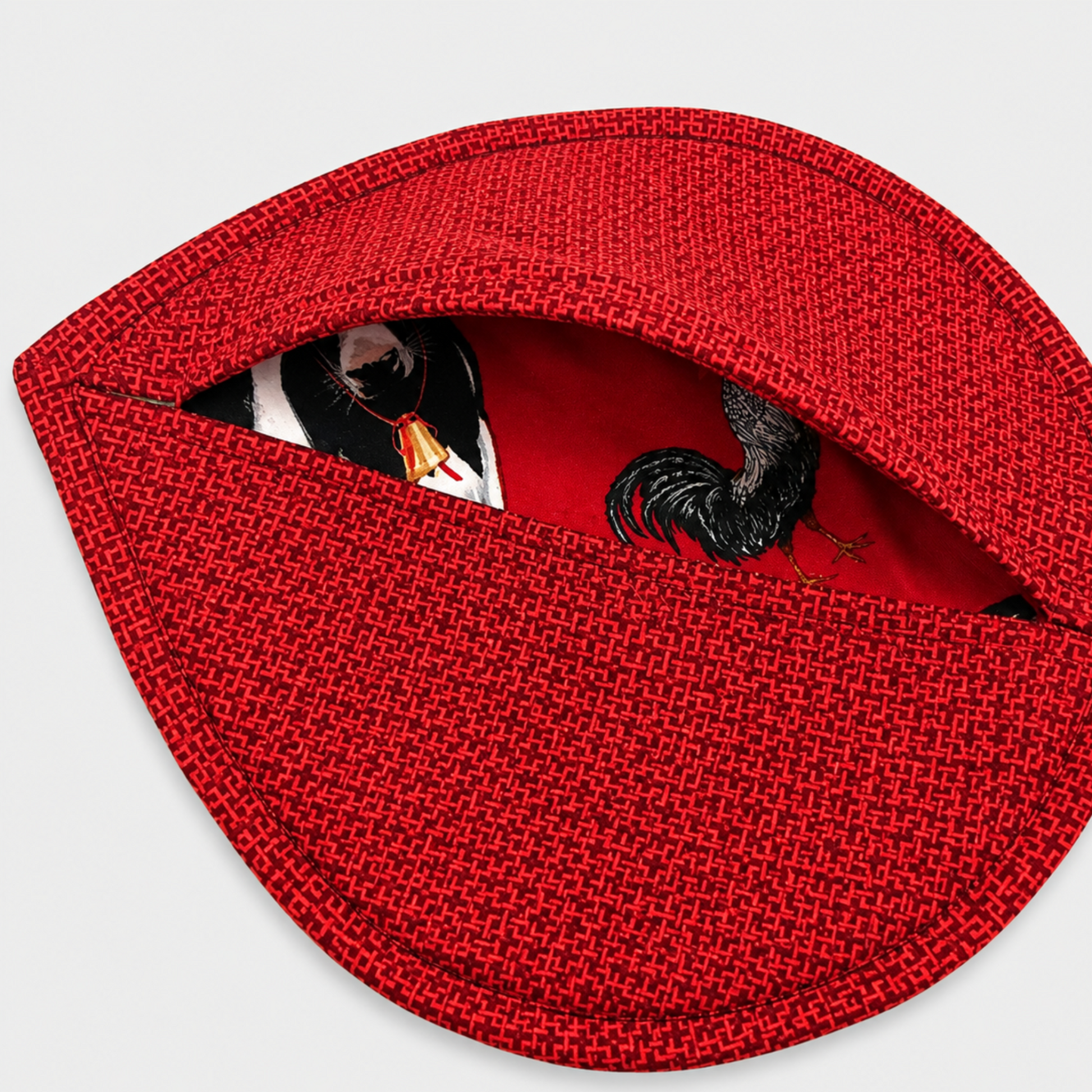 Leaf-Shaped Quilted Hot Pad – Christmas Red folded open to reveal coordinating farm animal lining fabric with cows and roosters – handmade by IraRobi Quilts