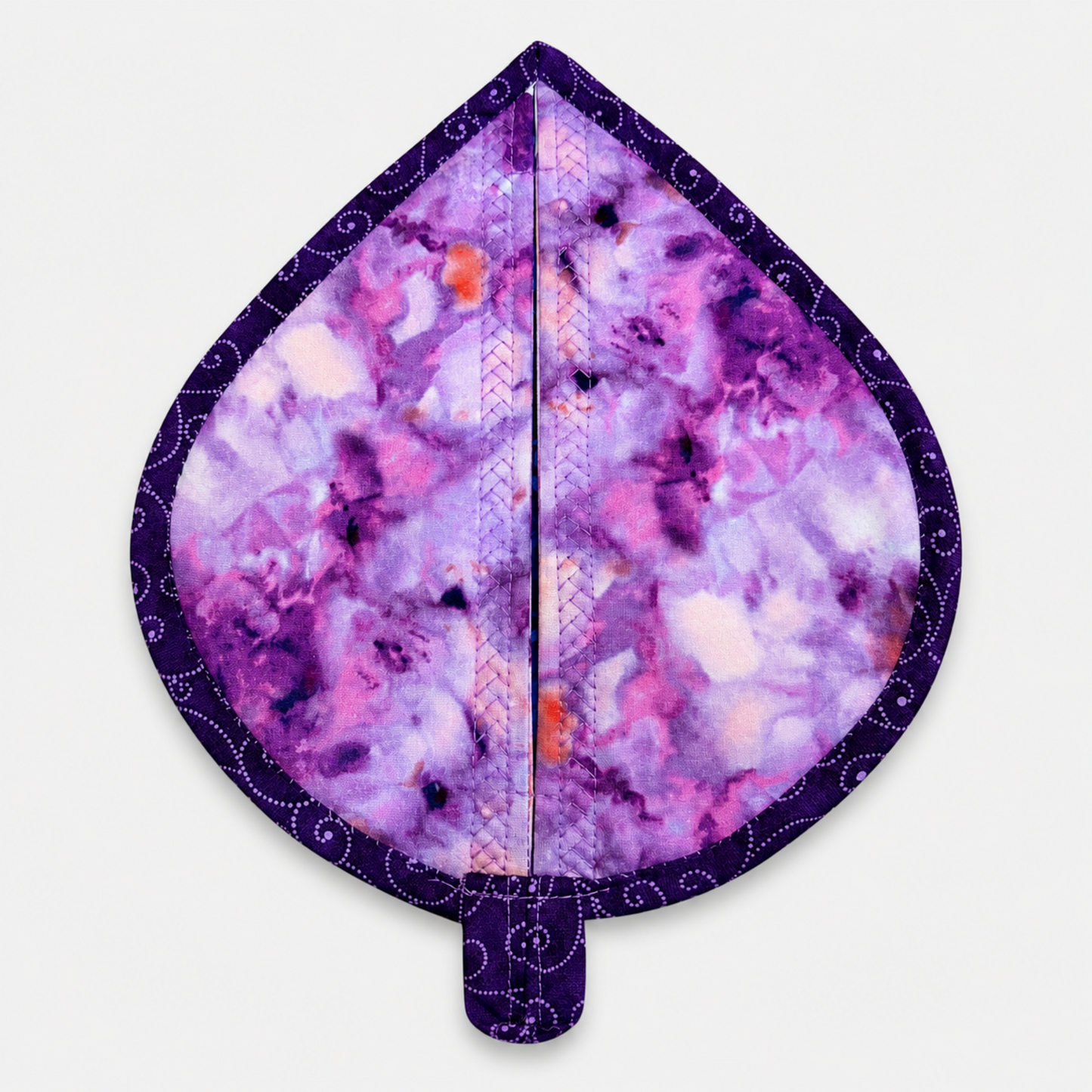 Leaf-Shaped Quilted Hot Pad – Lavender Garden, back view showing purple watercolor batik fabric with deep purple dot-swirl border binding and hanging loop – handmade by IraRobi Quilts