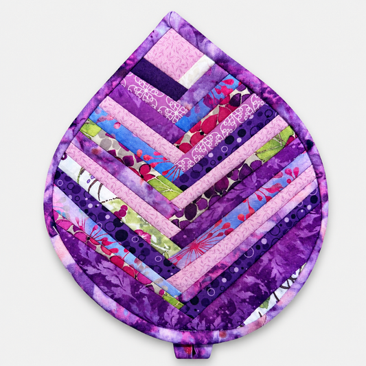 Leaf-Shaped Quilted Hot Pad – Violet Jewel, front view showing herringbone chevron strip piecing in rich jewel-tone purples with purple batik border – handmade by IraRobi Quilts
