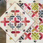Criss Cross Kisses quilt pattern by Robin Pickens — two stunning colorways side by side! X blocks and arrowhead sashing in crimson/navy and green/pink on cream. Shop at IraRobi Quilts! #QuiltPattern #RobinPickens #XBlock #ModernQuilt #FatEighth