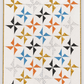 Writing on the Wall Going Places White quilting cotton by Sew Kind of Wonderful for FreeSpirit Fabrics — shown in the Lattice Revival Quilt Pattern by Sew Kind of Wonderful with coordinating orange, blue, gold, black, and white fabrics on an off-white background with gold border. Coordinating fabrics and quilt patterns available at IraRobi Quilts.