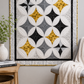 Cathedral windows star quilt in white, black, grey, and golden yellow using Writing on the Wall FreeSpirit fabrics — wall display