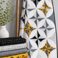 Writing on the Wall Well Worded White quilting cotton by FreeSpirit Fabrics — shown in the Lattice Revival Quilt Pattern by Sew Kind of Wonderful draped on a wooden ladder alongside coordinating Writing on the Wall fabrics in black, grey, and gold. Coordinating fabrics and quilt patterns available at IraRobi Quilts.