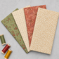 Fox Homestead Pink Leaves and Berries Fabric by Stacy West for Henry Glass — shown in a coordinating fan with matching Fox Homestead collection fabrics in sage green floral vine, cream ditsy, and terracotta floral, with burgundy, red, and gold thread spools. Quilt blocks shown for inspiration. Coordinating fabrics and quilt patterns are available at IraRobi Quilts.