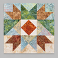 Sunset quilt block from the Windsong Block of the Month program by Wing and a Prayer Design, shown in coordinating cream, blue, green, gold, rust, and brown Tonga Batiks. Quilt block shown for inspiration. Coordinating fabrics and quilt patterns are available at IraRobi Quilts.