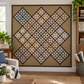 Rudy's Farm Quilt Pattern by Jill Shaulis for Yellow Creek Quilt Designs — 63"×63" scrappy snowflake block quilt displayed on a white wall in a cozy quilting room with wood shelving, fabric bolts, and potted plants. Blocks set on point in blues, reds, greens, golds, and purples on cream with dark brown sashing and tan background.