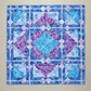 Fire & Ice handmade geometric quilt laid flat with blue and violet batik fabrics
