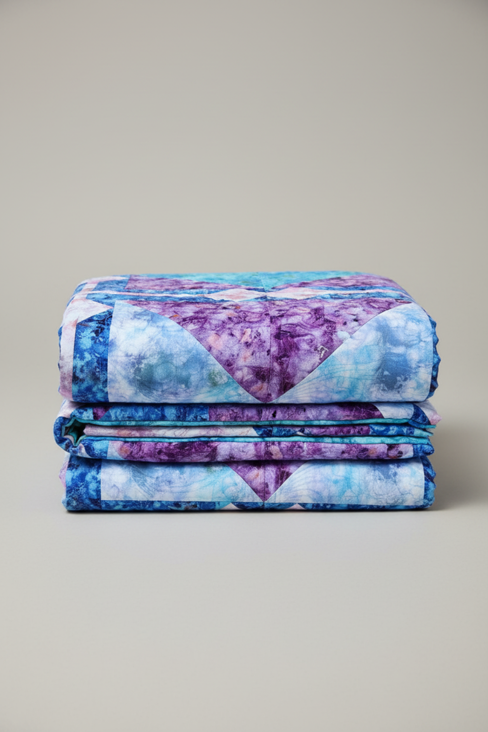 Folded Fire & Ice handmade quilt highlighting thickness and textured quilting