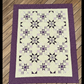 Handmade I Love Purple quilt with star blocks laid flat outdoors