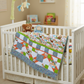 Nursery with a crib featuring a colorful quilt, teddy bear, and books.