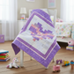 Purple quilt with geometric pattern draped over a chair in a child's room with toys around
