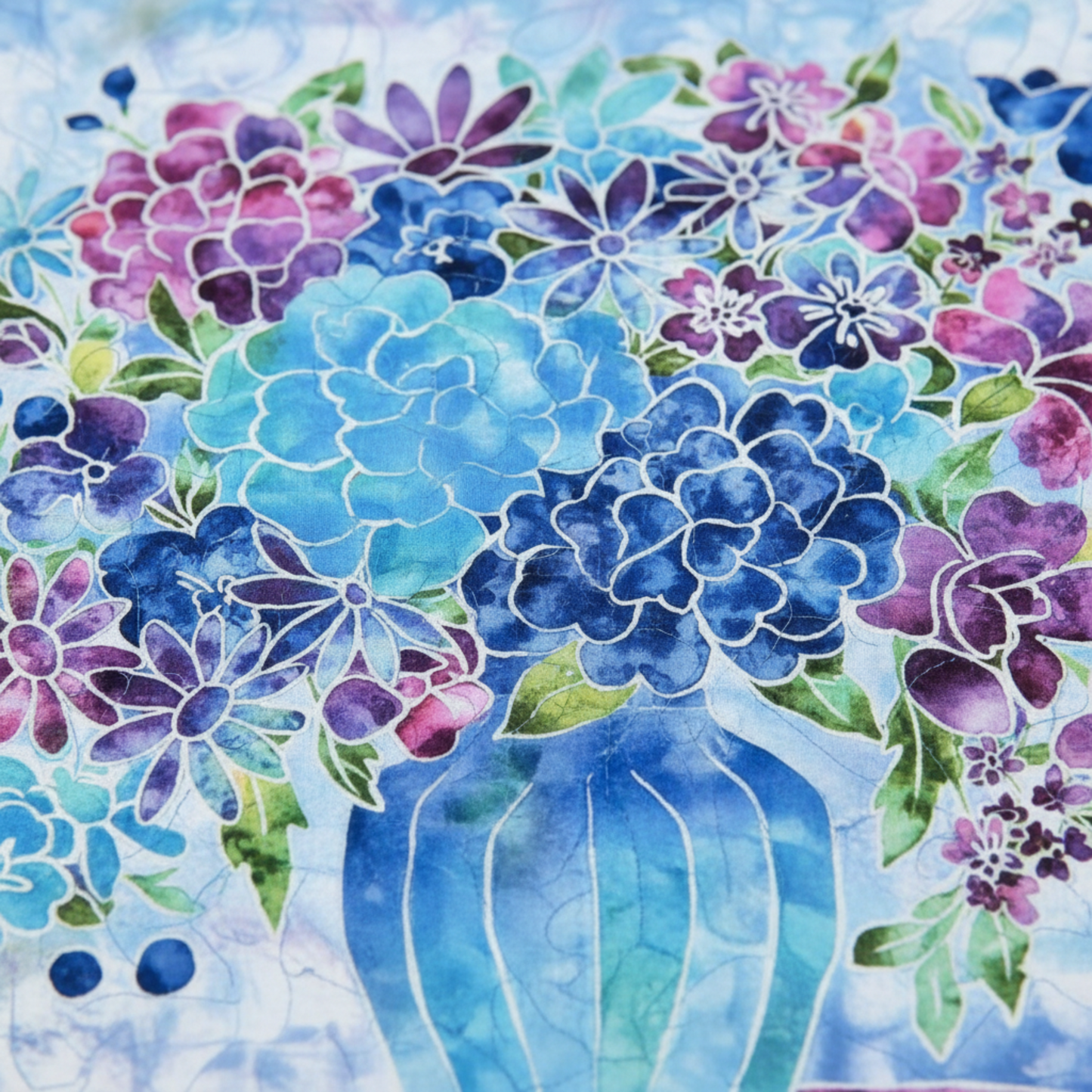 Colorful floral design with blue and purple flowers in a vase on a light blue background