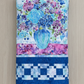 Elegant handmade floral quilt with blue and purple flowers and hummingbird accents.