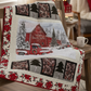 Quilt with a red barn and truck design on a wooden chair in a cozy room.
