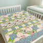 Quilt with animal pattern on a crib in a nursery setting