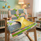 Colorful quilt draped over a wooden chair in a child's room with toys and books in the background.