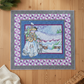 Quilt with a winter scene design on a wooden floor