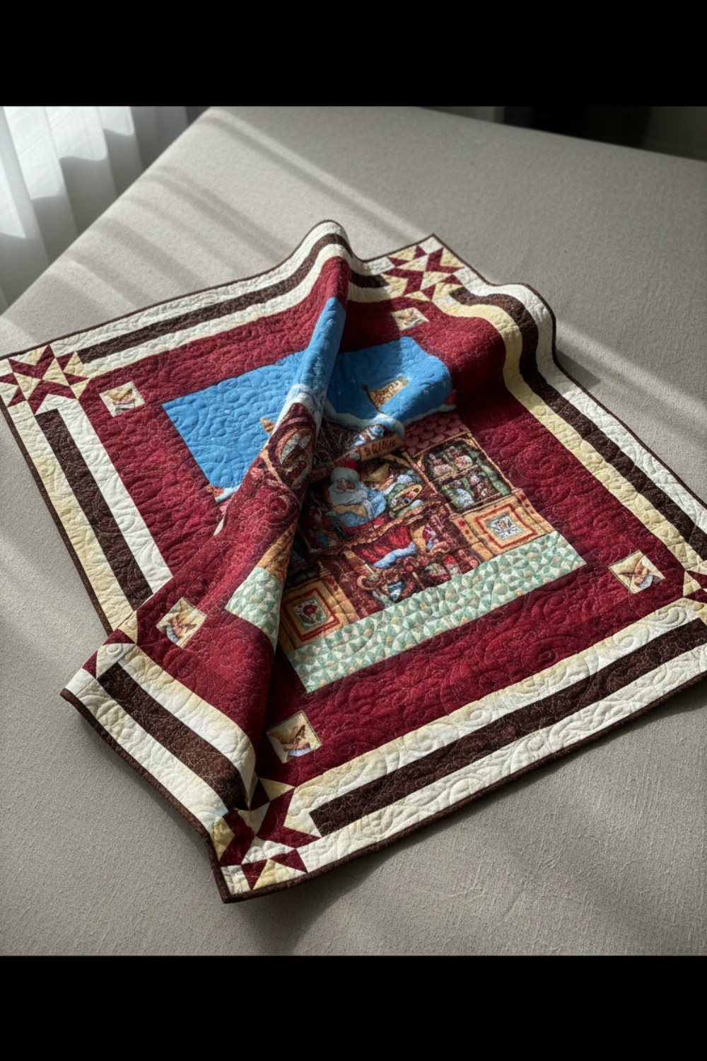 Festive handmade Christmas quilt with Santa working in his North Pole workshop, rich red borders, and classic holiday details.