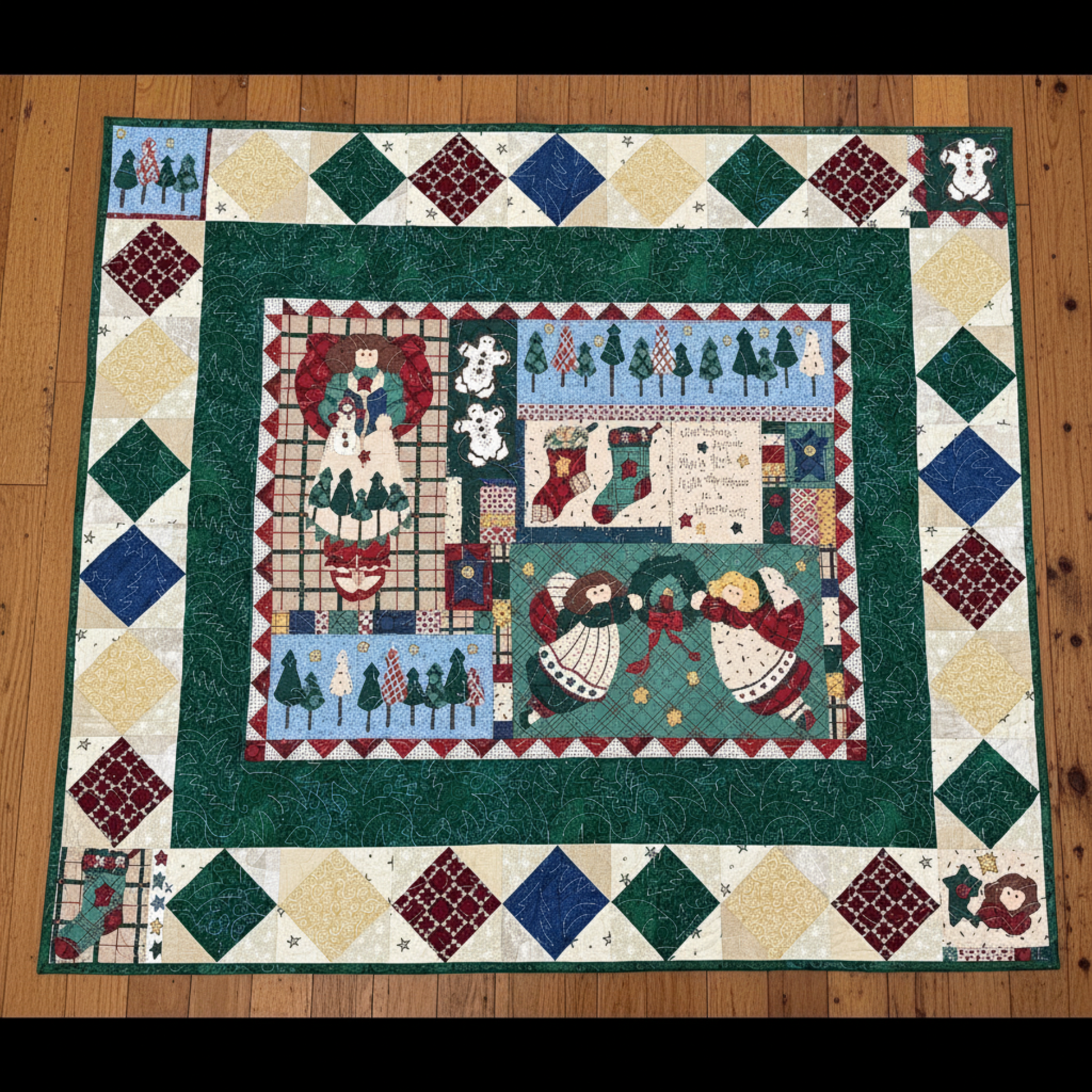 Quilt with Christmas-themed design on a wooden floor