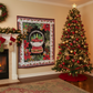 Decorative Christmas-themed quilt with a snow globe design featuring a red truck and surrounded by festive elements.